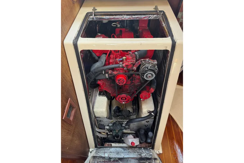Slide: The Image of Engine compartment of a 1987 Tartan 40 sailboat, featuring a red engine. - 22