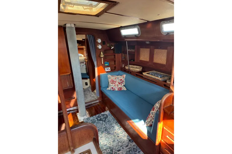Slide: The Image of Interior of a 1987 Tartan 40 sailboat with cozy seating and nautical decor. - 17