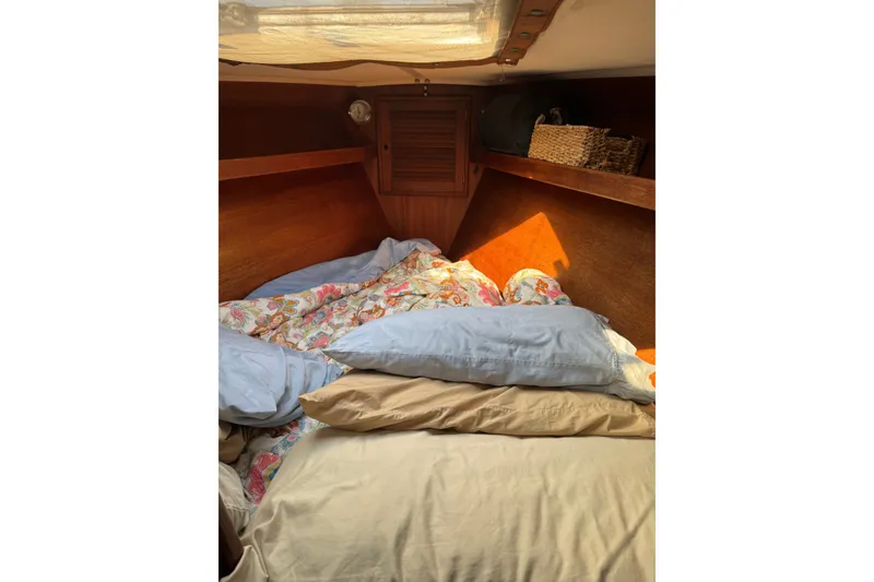 Slide: The Image of Cozy cabin interior of 1987 Tartan 40 sailboat with pillows and bedding. - 19
