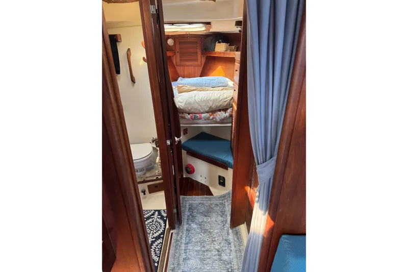 Slide: The Image of Cozy interior of a 1987 Tartan 40 sailboat with wooden finishes and a compact bathroom. - 18