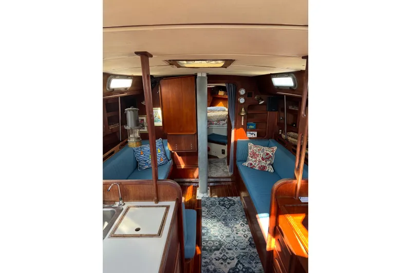 Slide: The Image of Interior of a 1987 Tartan 40 sailboat with cozy seating and nautical decor. - 15