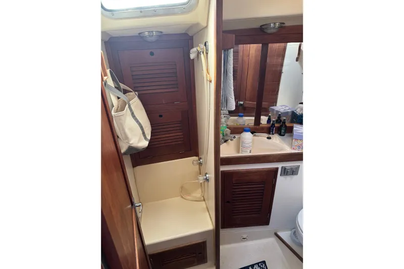Slide: The Image of Interior of 1987 Tartan 40 sailboat bathroom with wooden cabinets and sink. - 21