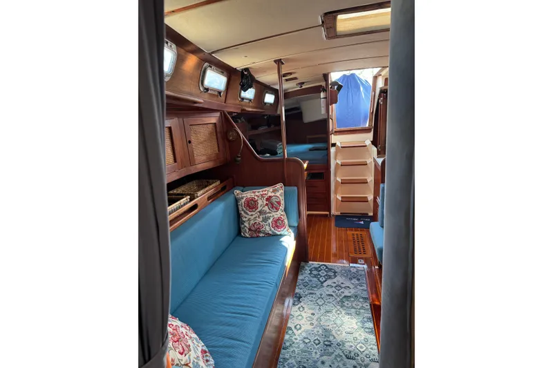 Slide: The Image of Interior of 1987 Tartan 40 sailboat with blue seating and wooden cabinetry. - 14