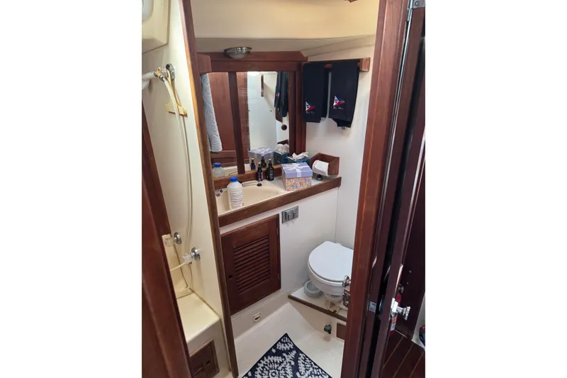 Slide: The Image of Bathroom interior of a 1987 Tartan 40 yacht, featuring wooden accents and nautical decor. - 20
