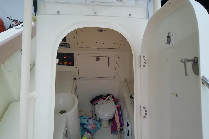 Slide: The Image of Interior of 2016 Release 301 RXS boat showing compact bathroom with toilet and sink. - 35
