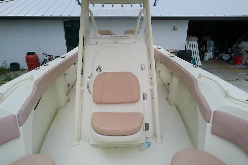 Slide: The Image of 2016 Release 301 RXS boat interior with beige seating and white deck. - 33