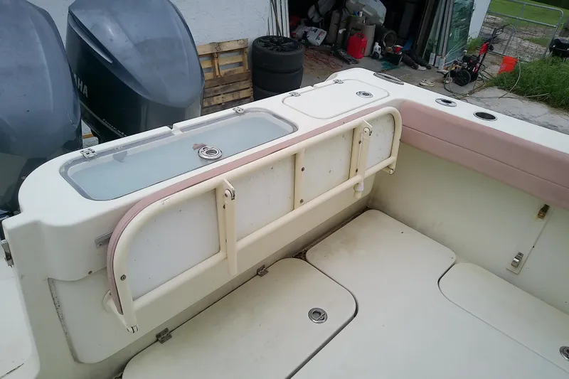 Slide: The Image of 2016 Release 301 RXS boat interior with storage compartments and dual Yamaha engines. - 22