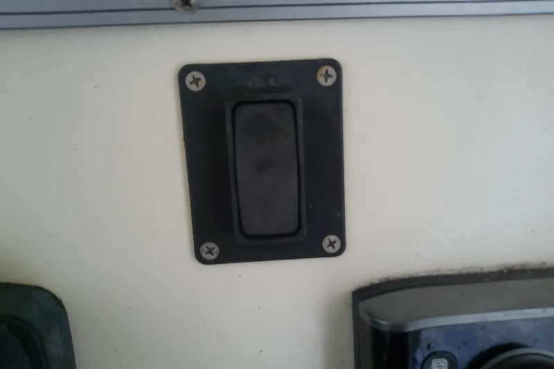 Slide: The Image of Black switch panel on a 2016 Release 301 RXS boat dashboard. - 18