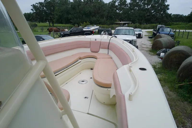 Slide: The Image of 2016 Release 301 RXS boat with spacious seating, parked outdoors near vehicles and hay bales. - 31