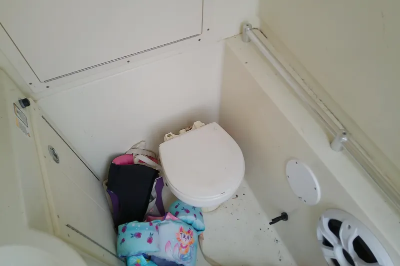 Slide: The Image of Boat bathroom with toilet and life jackets, Release 301 RXS, 2016 model. - 37