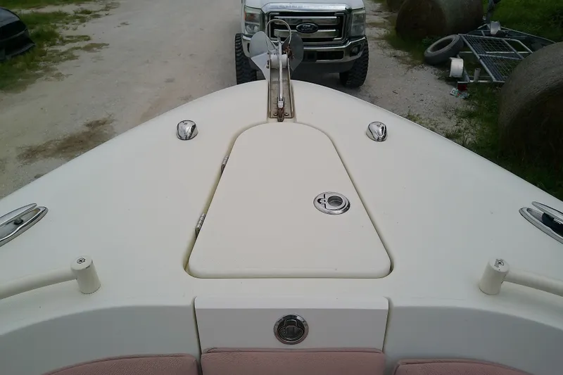 Slide: The Image of Bow of 2016 Release 301 RXS boat with anchor hatch, parked near a truck. - 32