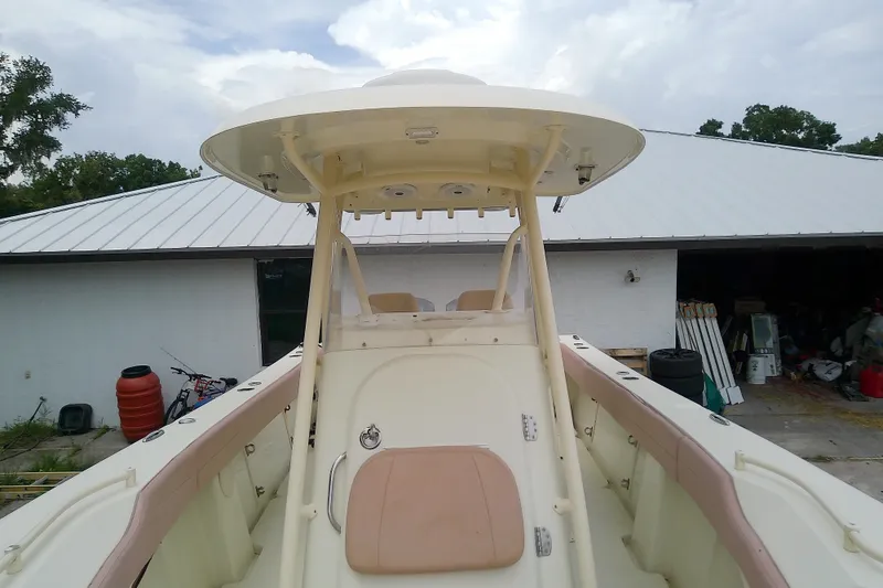 Slide: The Image of 2016 Release 301 RXS boat with T-top, docked near a white building. - 34