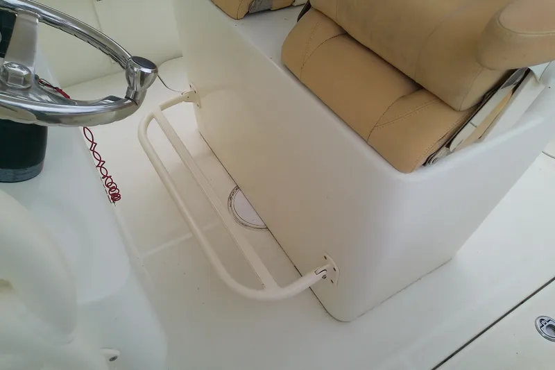Slide: The Image of Steering area of 2016 Release 301 RXS boat with beige seating and stainless steel wheel. - 28