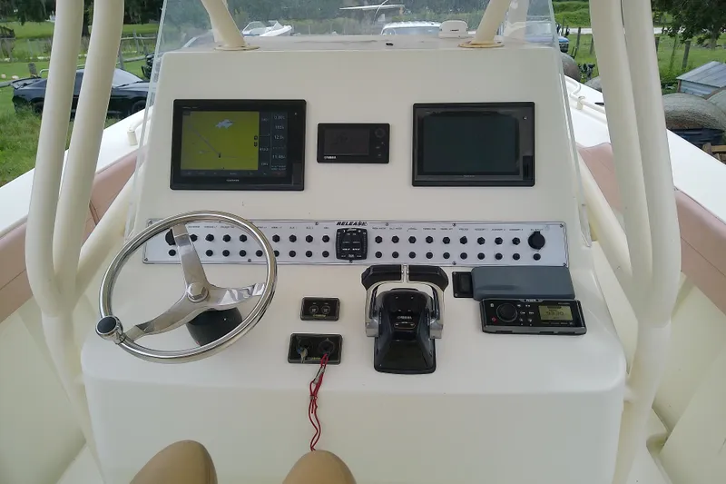Slide: The Image of Boat dashboard of 2016 Release 301 RXS with steering wheel and navigation screens. - 14