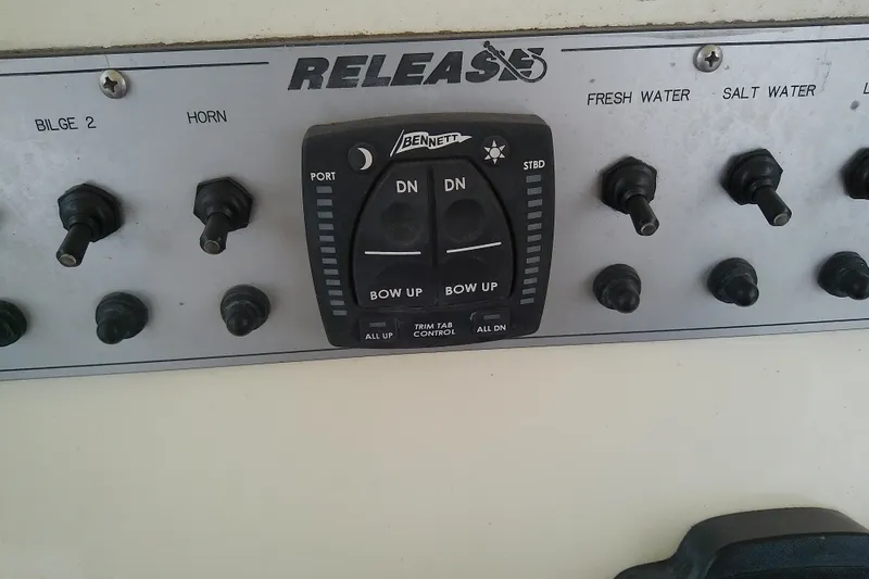 Slide: The Image of Control panel of a 2016 Release 301 RXS boat with switches and trim tab controls. - 17
