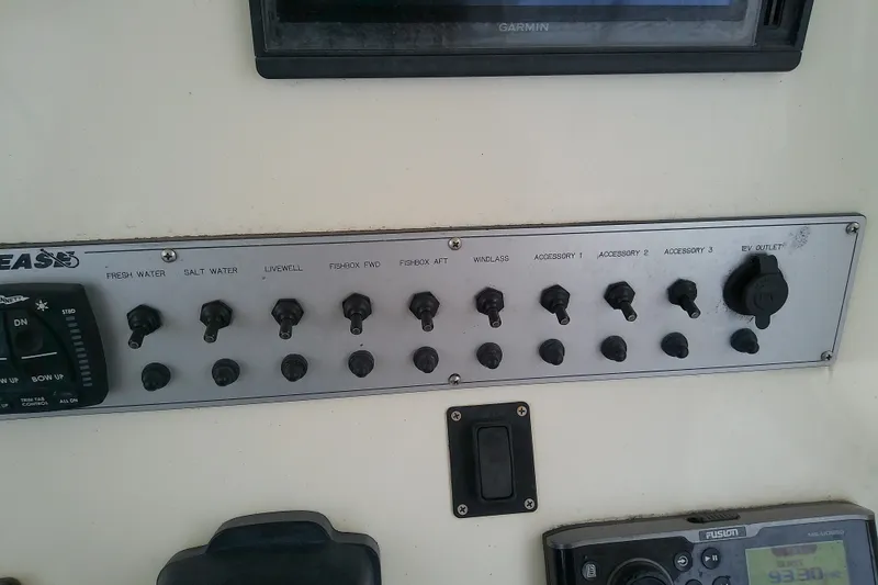 Slide: The Image of Control panel of a 2016 Release 301 RXS boat with various switches and outlets. - 19
