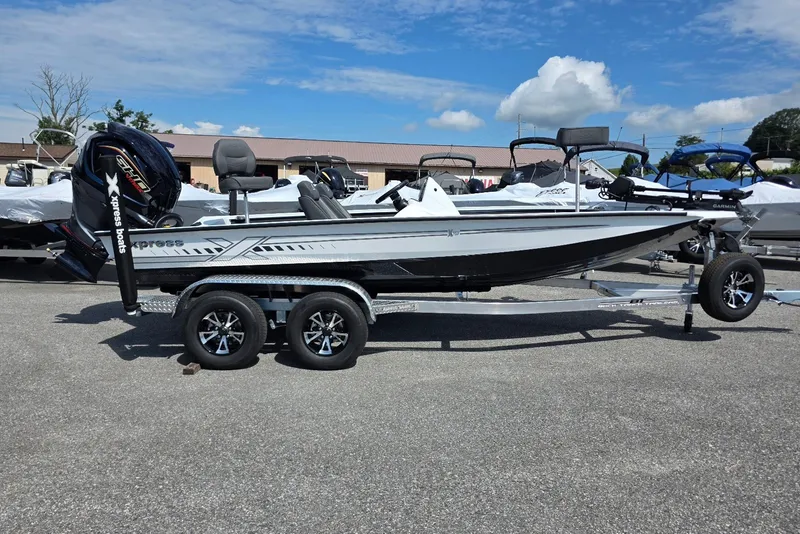 The Image of 2027 Xpress X19 Pro boat on trailer, featuring sleek design and powerful outboard motor. - 1