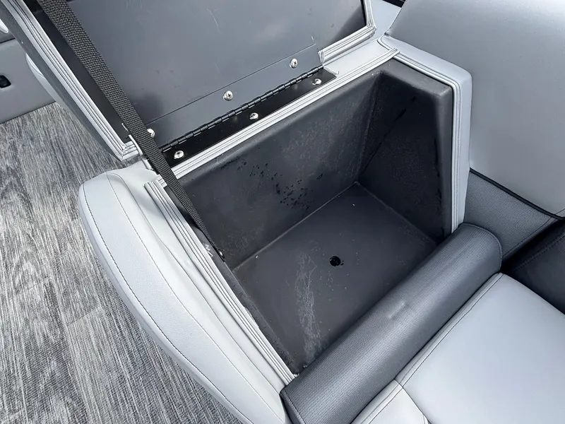 Slide: The Image of An open storage compartment in a gray seat on a boat. - 13