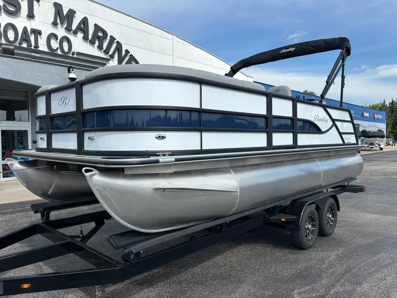 Slide: The Image of A 2027 Bentley Pontoons 200 Legacy Swingback on a trailer in front of a building. - 9