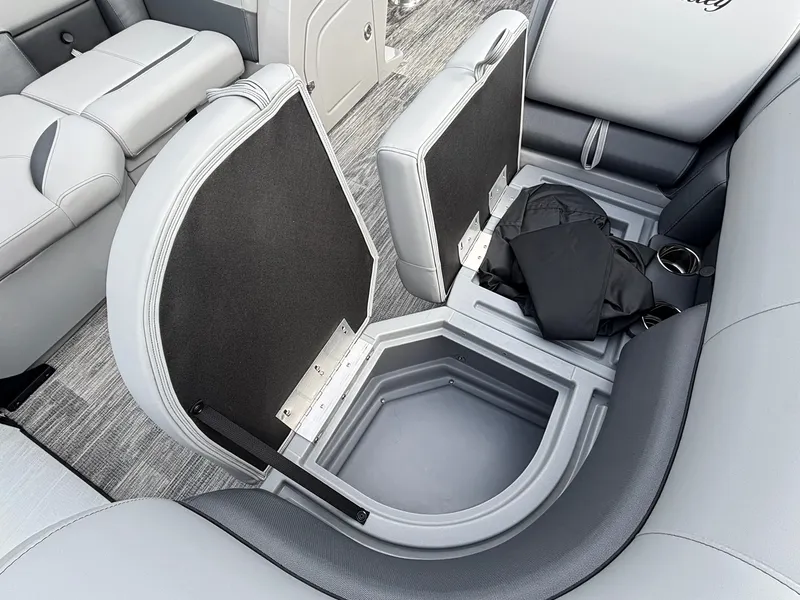 Slide: The Image of The 2027 Bentley Pontoons 200 Legacy Swingback features an open storage compartment beneath the seats. - 8