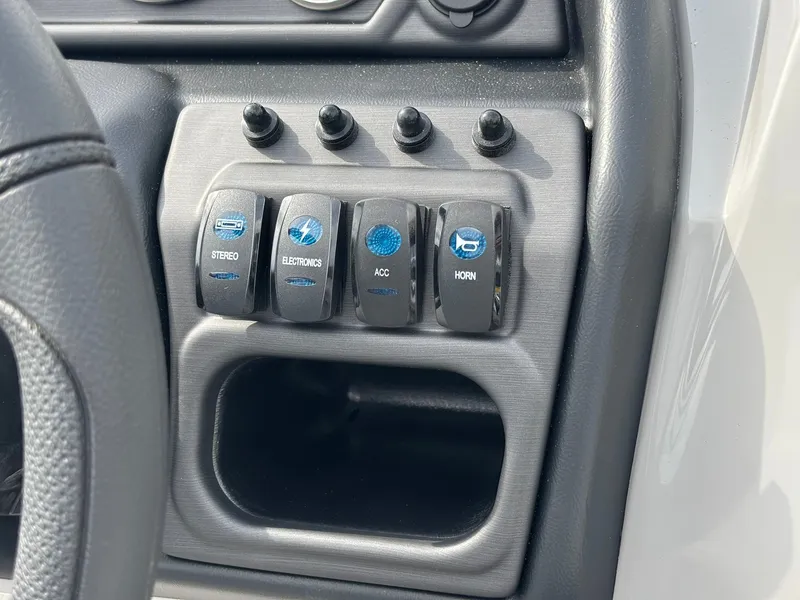 Slide: The Image of Close-up of a control panel area with four toggle switches for stereo, electronics, accessory, and horn. - 22
