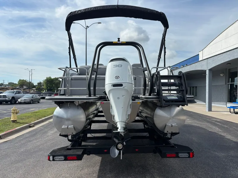 Slide: The Image of A 2027 Bentley Pontoons 200 Legacy Swingback on a trailer. The engine is visible. - 3