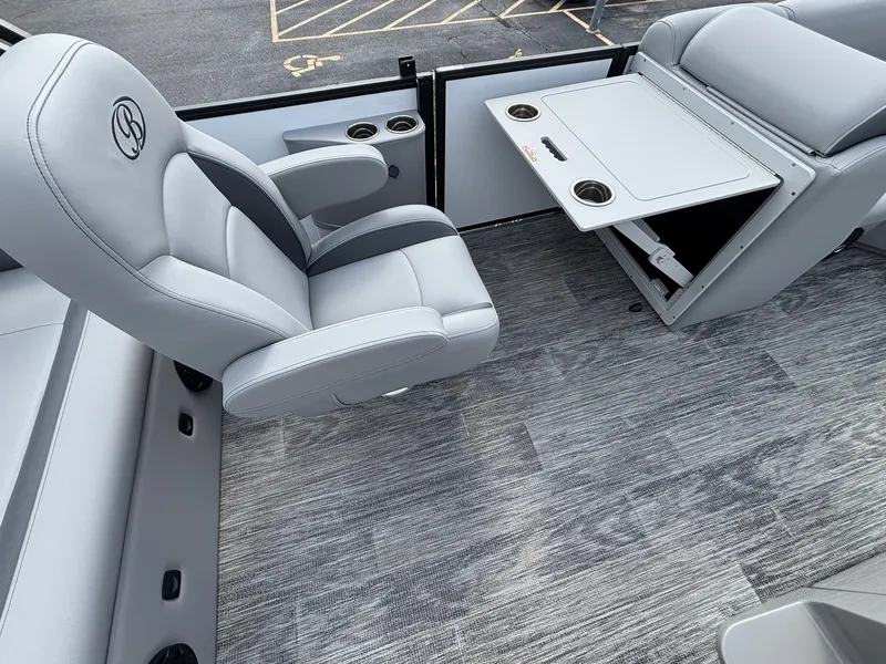 Slide: The Image of Gray leather seats and a foldable table on a boat with wood flooring. - 16