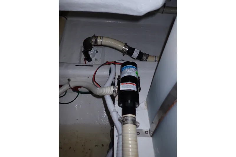 Slide: The Image of Bilge pump system in a 2005 Bertram 390 boat, featuring hoses and wiring. - 102