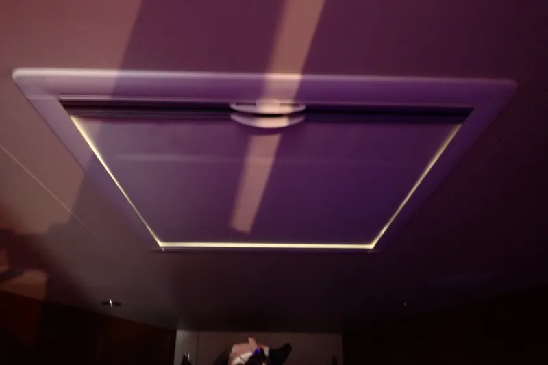 Slide: The Image of Ceiling hatch inside a 2005 Bertram 390 boat, illuminated with soft lighting. - 91
