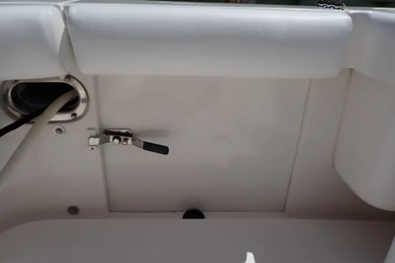 Slide: The Image of Interior view of a 2005 Bertram 390 boat, featuring a white cushioned panel and hardware. - 109
