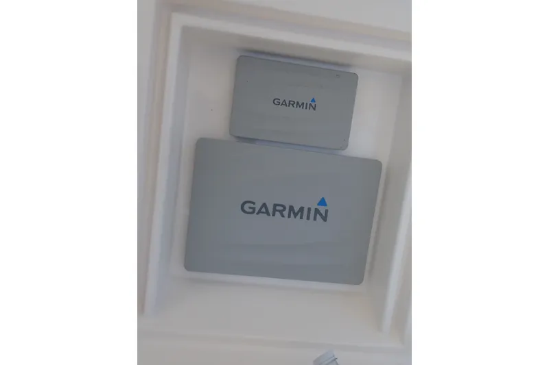 Slide: The Image of Garmin devices installed on a 2005 Bertram 390 boat dashboard. - 41