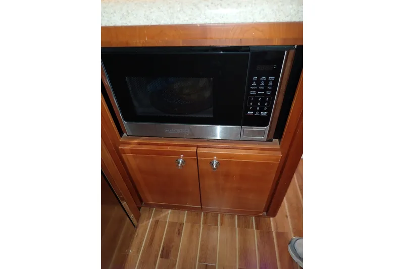 Slide: The Image of Built-in microwave in 2005 Bertram 390 yacht kitchen, wooden cabinetry. - 54