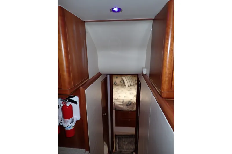 Slide: The Image of Interior of 2005 Bertram 390 yacht, featuring hallway and cozy cabin. - 49