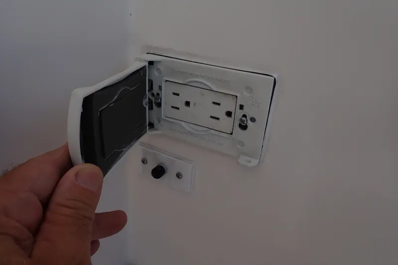 Slide: The Image of Electrical outlet with protective cover on a 2005 Bertram 390 boat. - 12