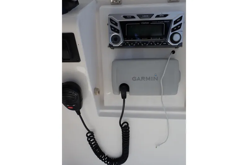 Slide: The Image of Boat dashboard with Clarion stereo, Garmin device, and microphone on a 2005 Bertram 390. - 43