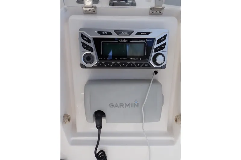 Slide: The Image of Clarion marine stereo and Garmin device on 2005 Bertram 390 boat dashboard. - 42