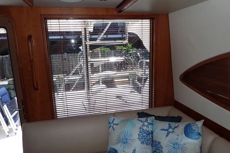 Slide: The Image of Interior of 2005 Bertram 390 yacht with window blinds and decorative pillows. - 64
