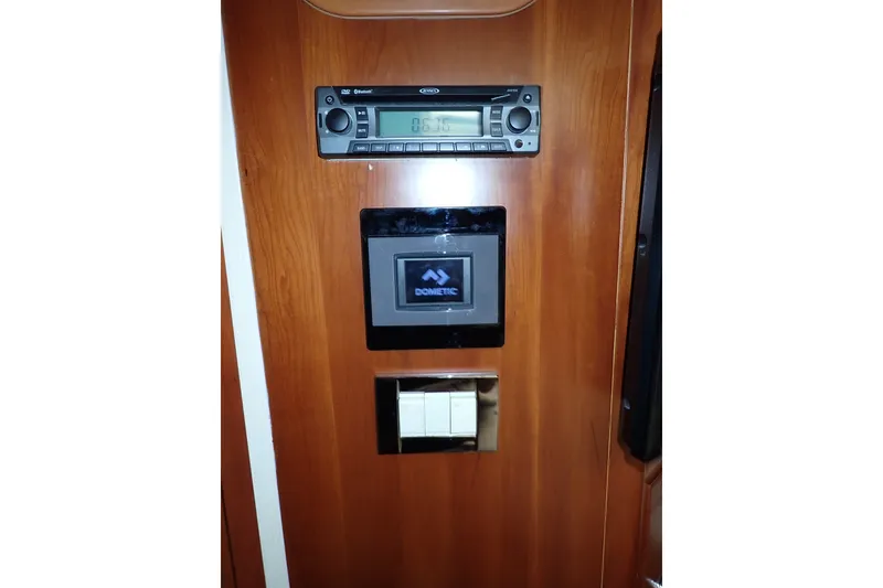 Slide: The Image of Control panel on a 2005 Bertram 390 yacht with audio system and Dometic display. - 86