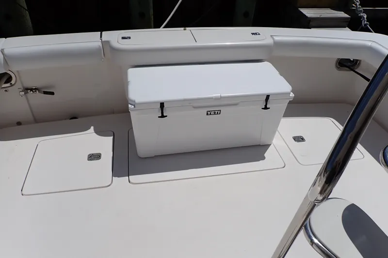 Slide: The Image of 2005 Bertram 390 boat deck with Yeti cooler, featuring storage compartments. - 110