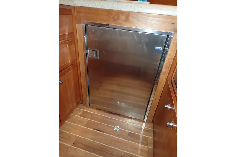 Slide: The Image of Stainless steel refrigerator in 2005 Bertram 390 yacht kitchen with wooden cabinetry. - 53