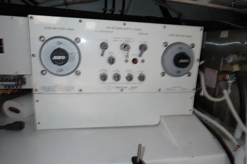 Slide: The Image of Control panel of a 2005 Bertram 390 yacht, featuring battery and generator switches. - 135