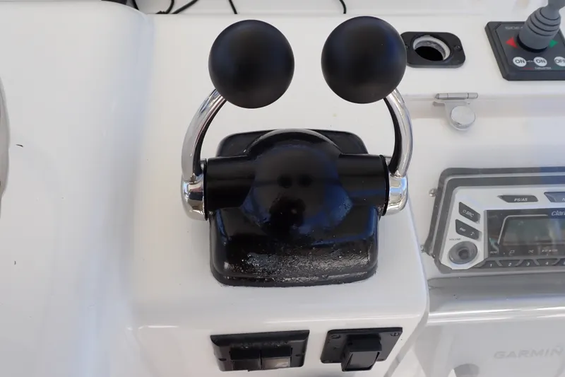 Slide: The Image of Throttle controls on a 2005 Bertram 390 boat dashboard with navigation equipment. - 45