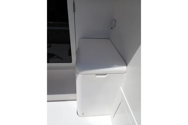 Slide: The Image of 2005 Bertram 390 boat interior storage compartment with white lid. - 10