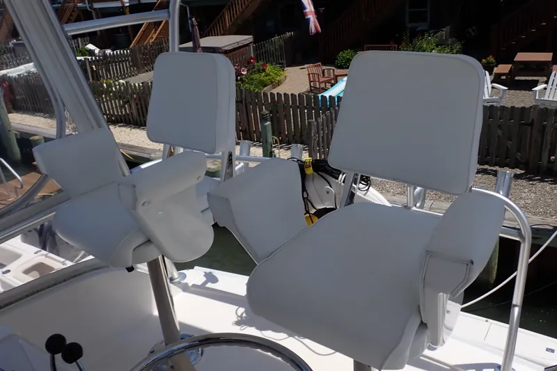 Slide: The Image of White captain's chairs on a 2005 Bertram 390 boat, dockside view. - 38