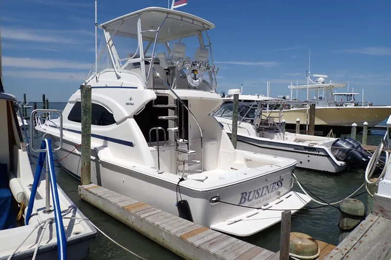 Slide: The Image of 2005 Bertram 390 yacht docked at marina under clear blue sky. - 7