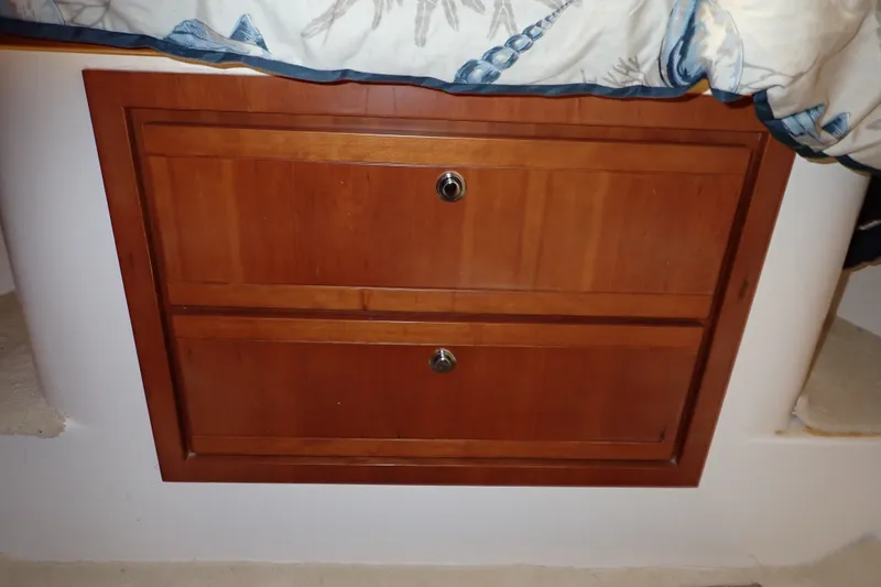 Slide: The Image of Wooden cabinet drawers on a 2005 Bertram 390 boat interior. - 88