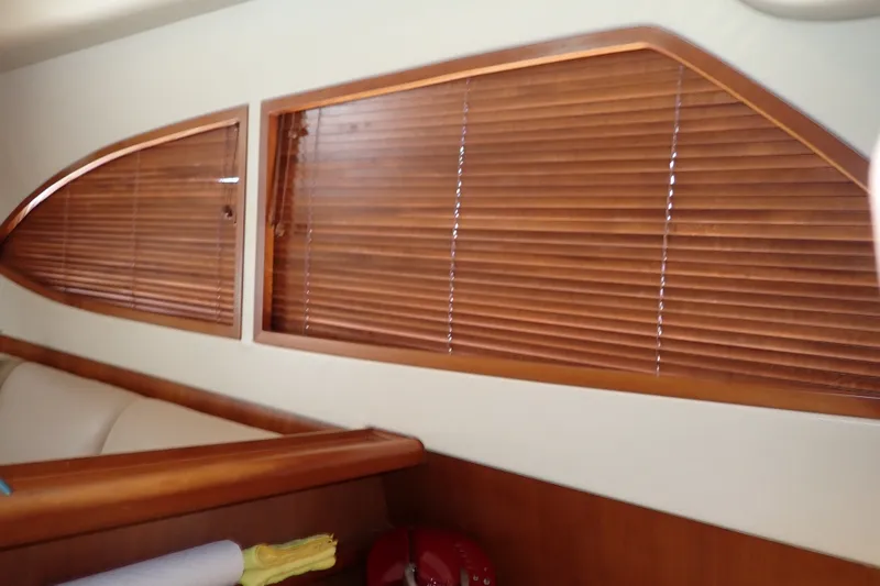 Slide: The Image of Interior of 2005 Bertram 390 yacht with wooden blinds and elegant furnishings. - 62
