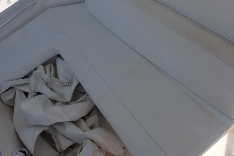 Slide: The Image of White seating area on a 2005 Bertram 390 boat with stored fabric. - 36