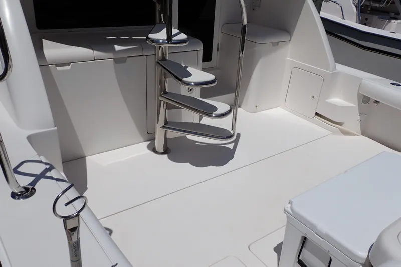 Slide: The Image of 2005 Bertram 390 yacht interior with sleek white design and spiral staircase. - 18
