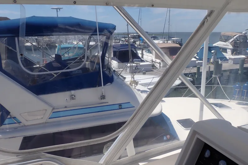Slide: The Image of Bertram 390 yacht from 2005 docked at a marina with other boats. - 35
